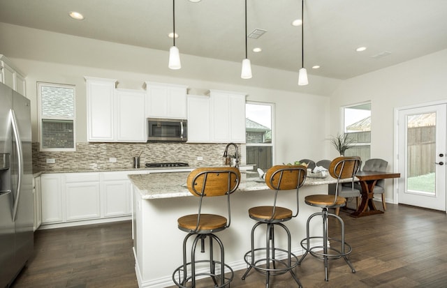 15898 Hayes Market Loop, Conroe, TX 77302 - kitchen featuring stainless steel appliances, recessed lighting, decorative backsplash, light stone counters, and dark wood-type flooring