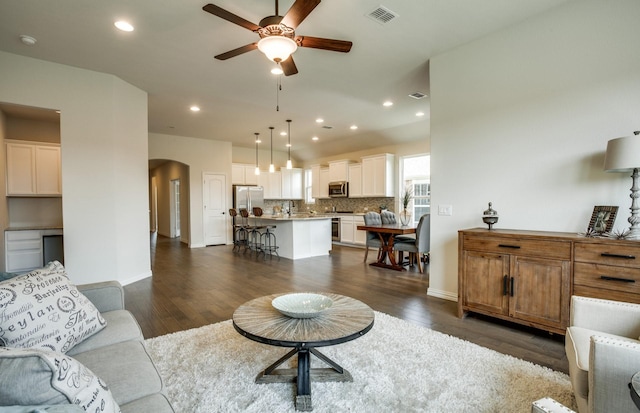 15898 Hayes Market Loop, Conroe, TX 77302 - living room with arched walkways, a ceiling fan, dark wood-style floors, and recessed lighting
