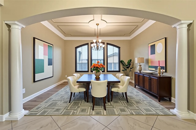 27814 Cenizo Park Ct, Katy, TX 77494 - dining room featuring decorative columns, arched walkways, a chandelier, crown molding, and wood finished floors