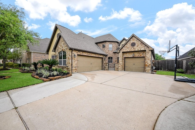 27814 Cenizo Park Ct, Katy, TX 77494 - french provincial home with a garage, concrete driveway, roof with shingles, stone siding, and brick siding