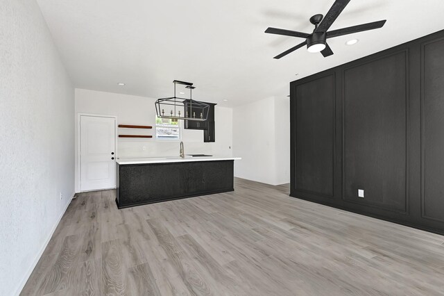 7939 Goode St, Houston, TX 77012 - unfurnished living room with ceiling fan, light wood finished floors, and recessed lighting