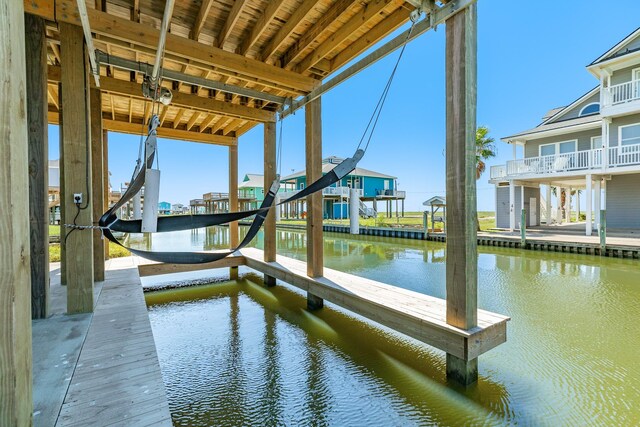 591 Pompano Dr, Freeport, TX 77541 - dock featuring a water view and boat lift