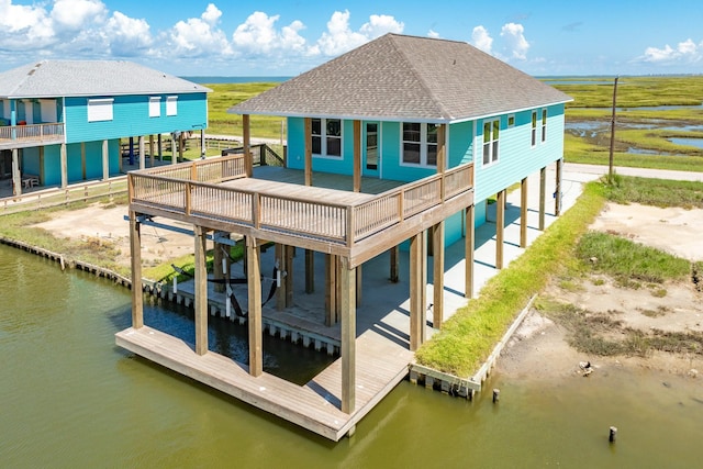591 Pompano Dr, Freeport, TX 77541 - rear view of house featuring a shingled roof and a deck with water view