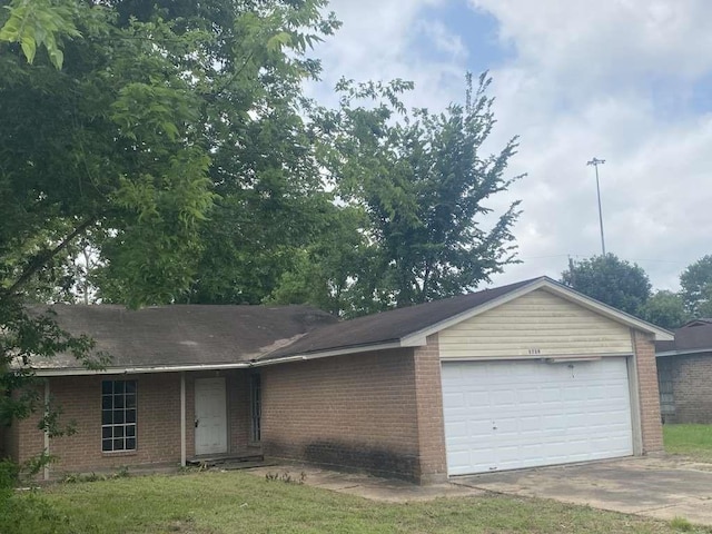 5739 Gatewood Ave, Houston, TX 77053 - ranch-style house featuring brick siding, an attached garage, and concrete driveway