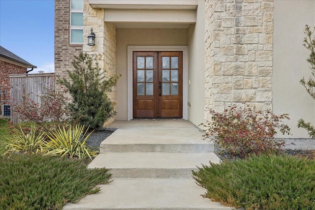 7722 Pond Cir, Beaumont, TX 77707 - property entrance with stone siding, french doors, and stucco siding