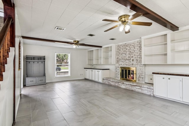 7927 Litchfield Ln, Spring, TX 77379 - unfurnished living room featuring a ceiling fan, a fireplace, stairs, and tile patterned flooring