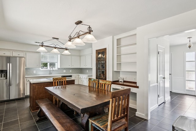7927 Litchfield Ln, Spring, TX 77379 - dining space with dark tile patterned flooring and built in shelves
