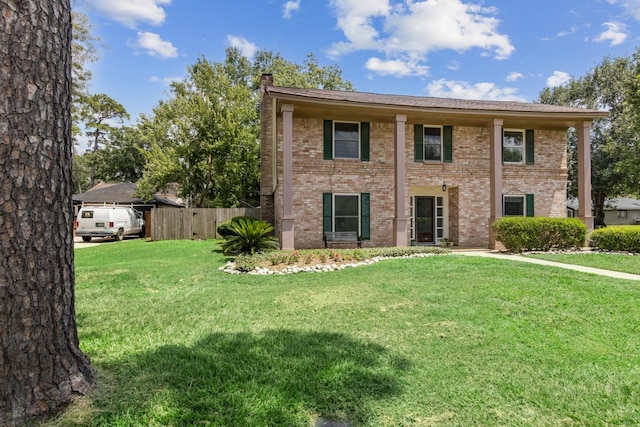 7927 Litchfield Ln, Spring, TX 77379 - view of front facade with a chimney and brick siding