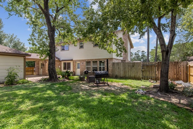 7927 Litchfield Ln, Spring, TX 77379 - rear view of house featuring brick siding and a gate