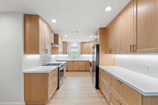 4406 Merwin St, Houston, TX 77027 - kitchen featuring stainless steel appliances, backsplash, light countertops, wall chimney range hood, and recessed lighting