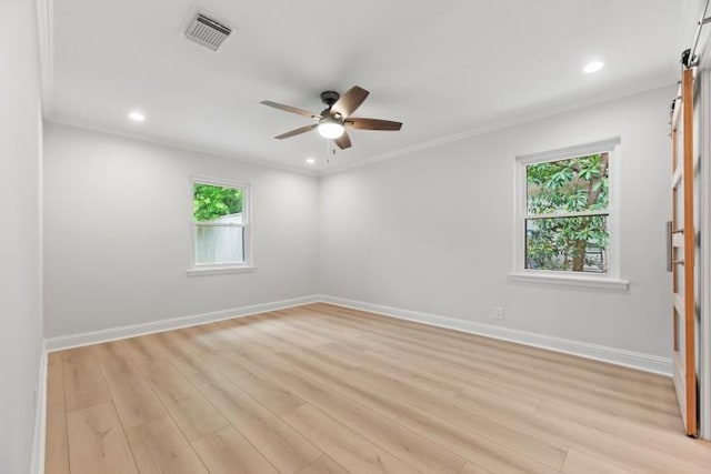 4406 Merwin St, Houston, TX 77027 - spare room with ceiling fan, light wood finished floors, recessed lighting, crown molding, and a barn door