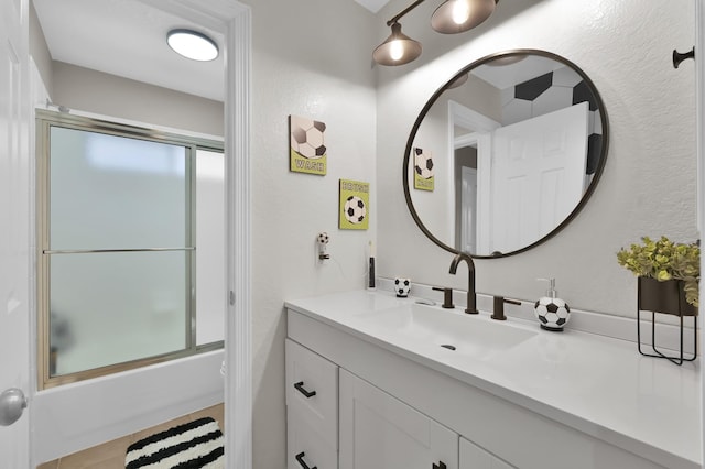 1415 Kennoway Park Dr, Spring, TX 77379 - full bathroom featuring vanity, enclosed tub / shower combo, and a textured wall