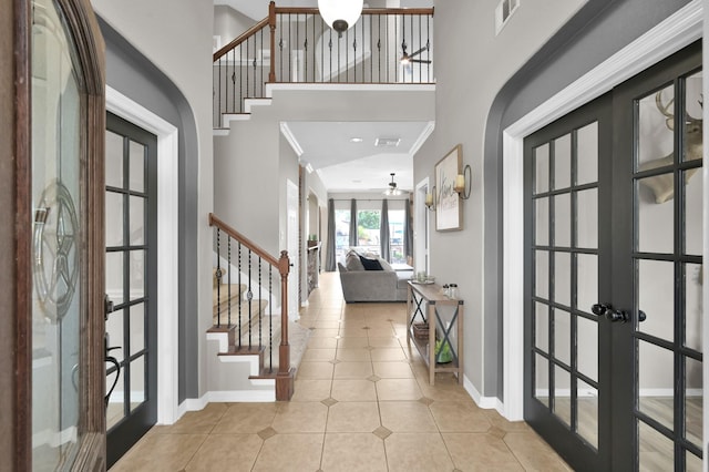 1415 Kennoway Park Dr, Spring, TX 77379 - tiled foyer entrance featuring french doors, stairs, ceiling fan, and a towering ceiling
