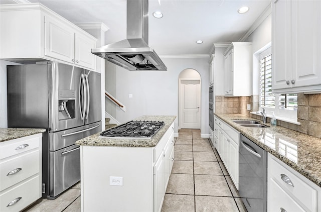 13322 Castlecombe Dr, Houston, TX 77044 - kitchen featuring appliances with stainless steel finishes, island exhaust hood, a kitchen island, crown molding, and decorative backsplash