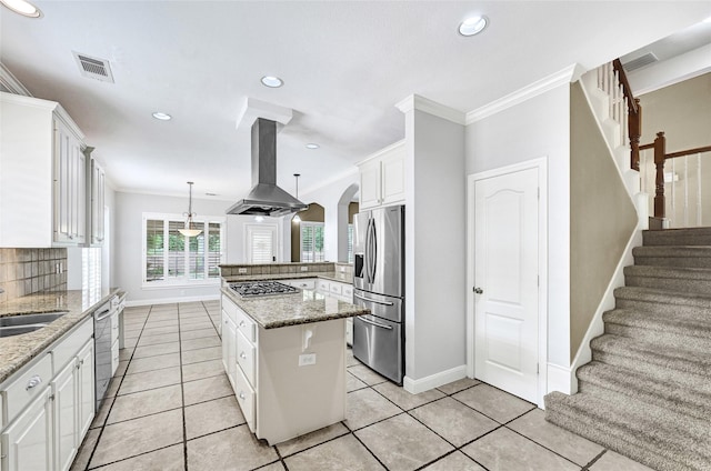 13322 Castlecombe Dr, Houston, TX 77044 - kitchen with appliances with stainless steel finishes, island range hood, decorative backsplash, crown molding, and a peninsula