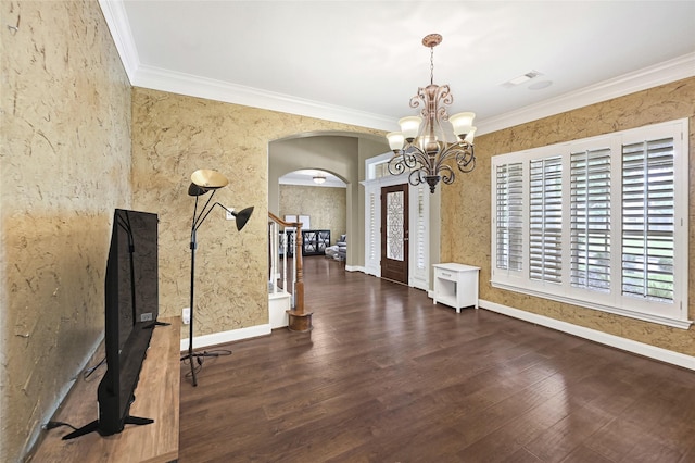 13322 Castlecombe Dr, Houston, TX 77044 - unfurnished dining area featuring arched walkways, ornamental molding, a chandelier, and wood finished floors