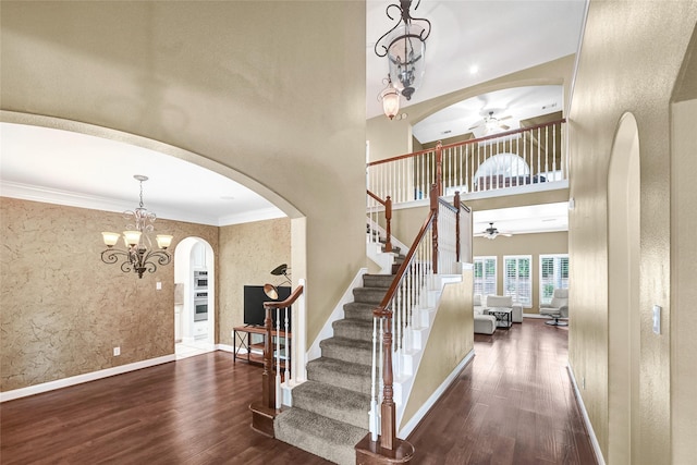 13322 Castlecombe Dr, Houston, TX 77044 - entryway with ceiling fan, arched walkways, wood finished floors, a towering ceiling, and crown molding