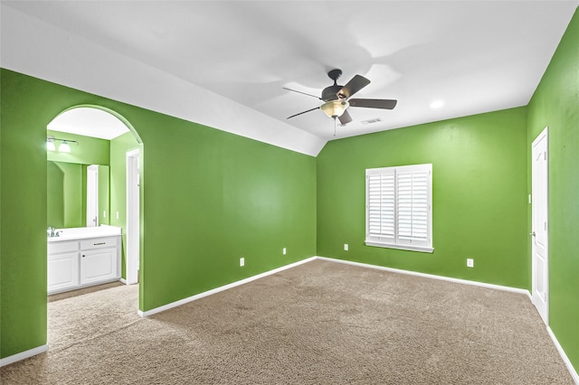 13322 Castlecombe Dr, Houston, TX 77044 - carpeted spare room featuring a ceiling fan, vaulted ceiling, and arched walkways