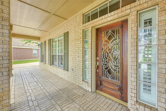 13322 Castlecombe Dr, Houston, TX 77044 - doorway to property featuring a porch and brick siding