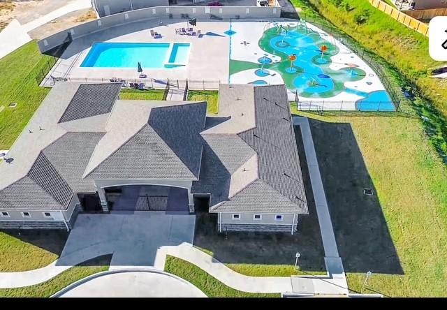 9971 Spring Creek Rd, Cleveland, TX 77327 - drone / aerial view of a pool area