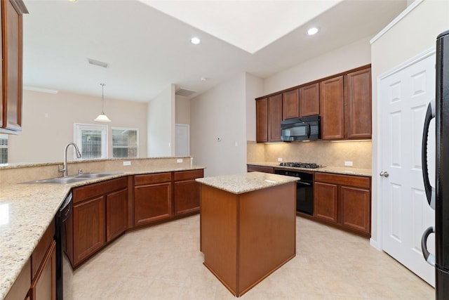 12714 Madera Canyon Ln, Tomball, TX 77377 - kitchen with black appliances, decorative backsplash, recessed lighting, light stone countertops, and decorative light fixtures