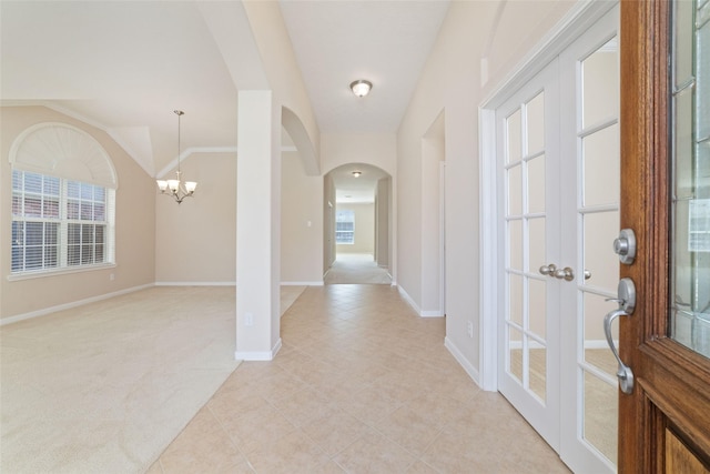 12714 Madera Canyon Ln, Tomball, TX 77377 - foyer featuring arched walkways, a chandelier, light tile patterned floors, and light carpet