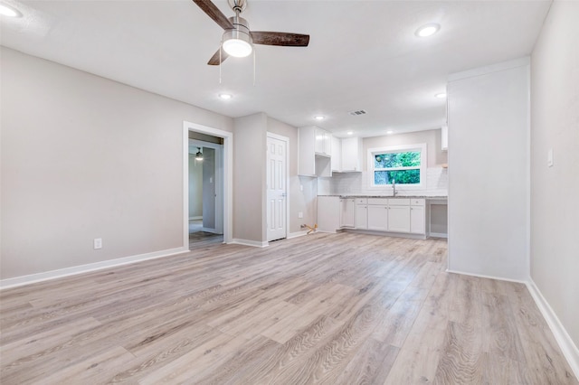 5858 Beldart St, Houston, TX 77033 - unfurnished living room with a ceiling fan, light wood-style flooring, and recessed lighting