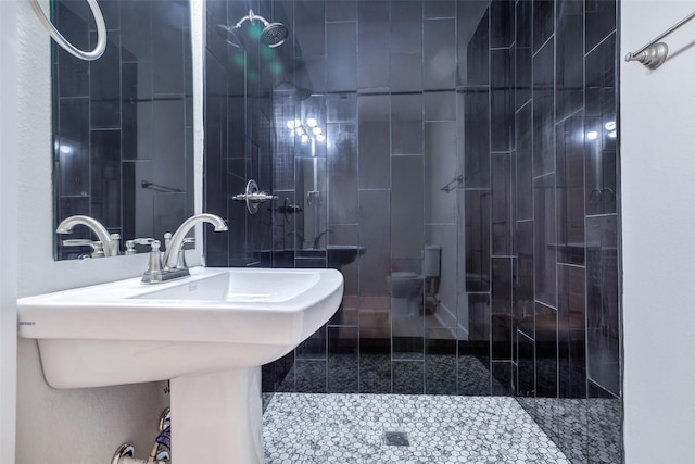 5858 Beldart St, Houston, TX 77033 - bathroom featuring a tile shower and a sink