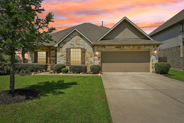 2018 Oxley Manor Ln, Richmond, TX 77469 - view of front facade featuring stone siding, concrete driveway, a front yard, an attached garage, and roof with shingles