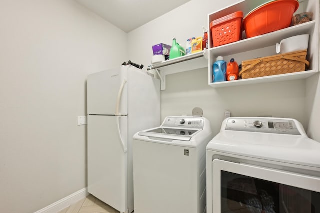 2018 Oxley Manor Ln, Richmond, TX 77469 - washroom with washing machine and clothes dryer and baseboards