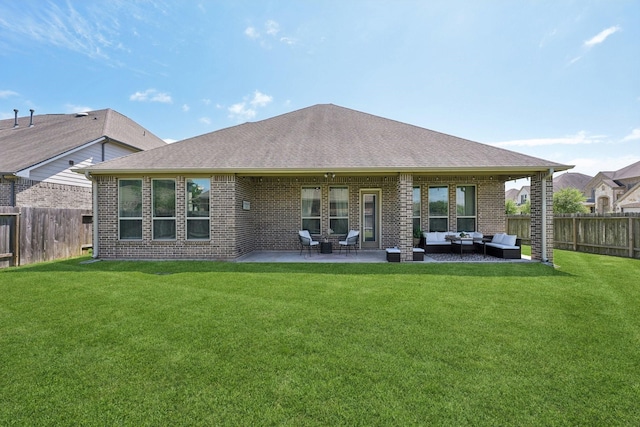 2018 Oxley Manor Ln, Richmond, TX 77469 - back of property featuring an outdoor living space, a fenced backyard, brick siding, a patio area, and roof with shingles