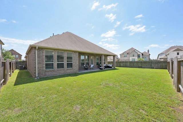 2018 Oxley Manor Ln, Richmond, TX 77469 - rear view of property featuring brick siding, a fenced backyard, and a patio area