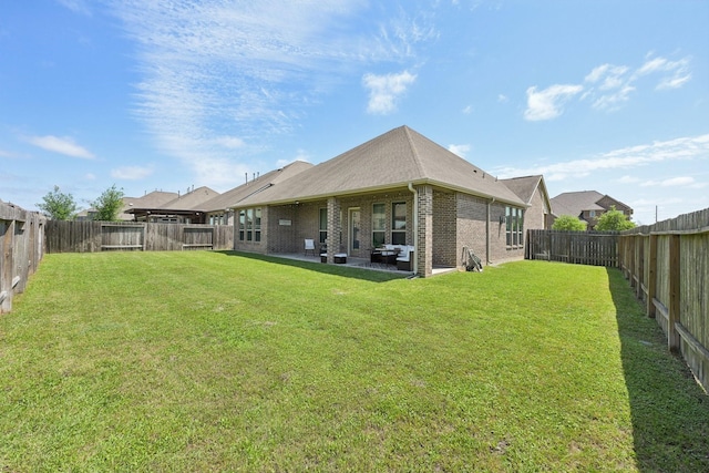 2018 Oxley Manor Ln, Richmond, TX 77469 - rear view of property featuring brick siding, a patio, and a fenced backyard