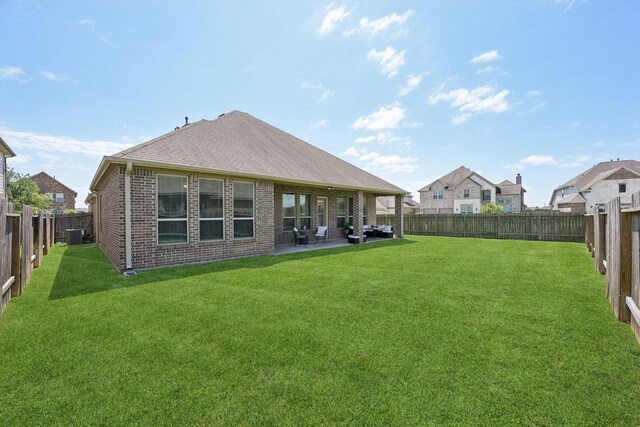 2018 Oxley Manor Ln, Richmond, TX 77469 - back of house featuring brick siding, a fenced backyard, and a patio area