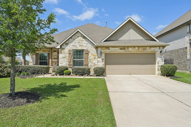 2018 Oxley Manor Ln, Richmond, TX 77469 - view of front of property with stone siding, a front lawn, an attached garage, and driveway