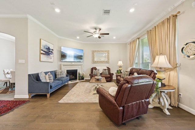 2018 Oxley Manor Ln, Richmond, TX 77469 - living area featuring ceiling fan, recessed lighting, arched walkways, wood finished floors, and crown molding
