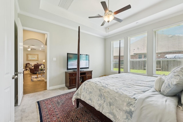 2018 Oxley Manor Ln, Richmond, TX 77469 - carpeted bedroom with a tray ceiling, multiple windows, crown molding, and a ceiling fan