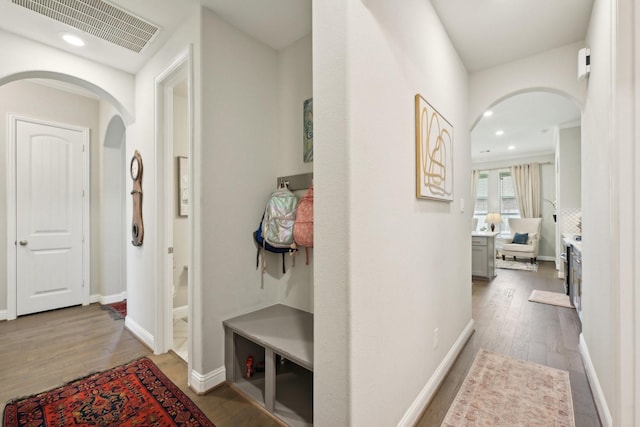 2018 Oxley Manor Ln, Richmond, TX 77469 - hall with arched walkways, wood finished floors, and recessed lighting