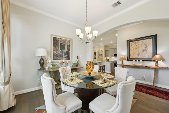 2018 Oxley Manor Ln, Richmond, TX 77469 - dining room featuring arched walkways, a chandelier, crown molding, dark wood-type flooring, and recessed lighting