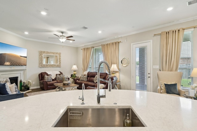 2018 Oxley Manor Ln, Richmond, TX 77469 - kitchen with open floor plan, a fireplace, recessed lighting, ornamental molding, and a ceiling fan
