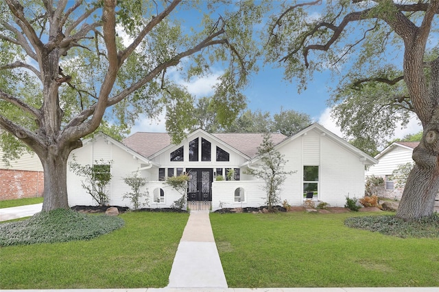 15702 Congo Ln, Jersey Village, TX 77040 - view of front of house with french doors, a front lawn, and roof with shingles