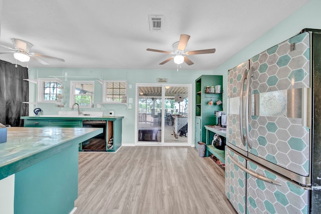 40670 Jozwiak Ln, Hempstead, TX 77445 - kitchen with ceiling fan, wood finished floors, fridge, and beverage cooler