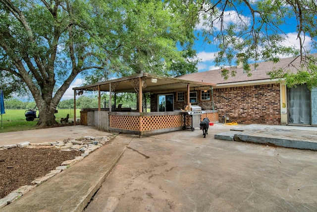 40670 Jozwiak Ln, Hempstead, TX 77445 - back of house featuring brick siding and a patio