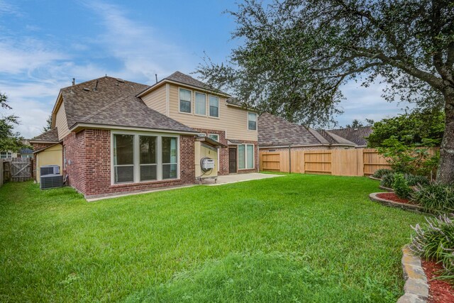 6103 Timbermoss Ct, League City, TX 77573 - rear view of house with brick siding, a shingled roof, a fenced backyard, and a patio area