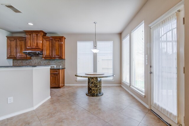 6103 Timbermoss Ct, League City, TX 77573 - kitchen featuring brown cabinetry, dark countertops, backsplash, and recessed lighting