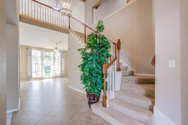6103 Timbermoss Ct, League City, TX 77573 - stairway with tile patterned floors, a towering ceiling, ceiling fan, and a chandelier