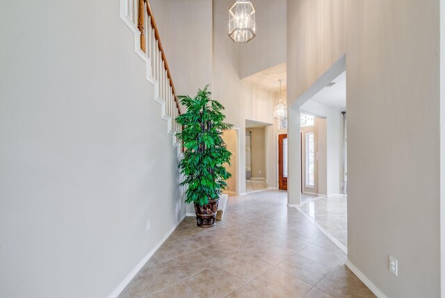 6103 Timbermoss Ct, League City, TX 77573 - hall with a towering ceiling, a chandelier, and light tile patterned floors