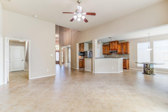 6103 Timbermoss Ct, League City, TX 77573 - unfurnished living room featuring plenty of natural light, a ceiling fan, and light tile patterned floors
