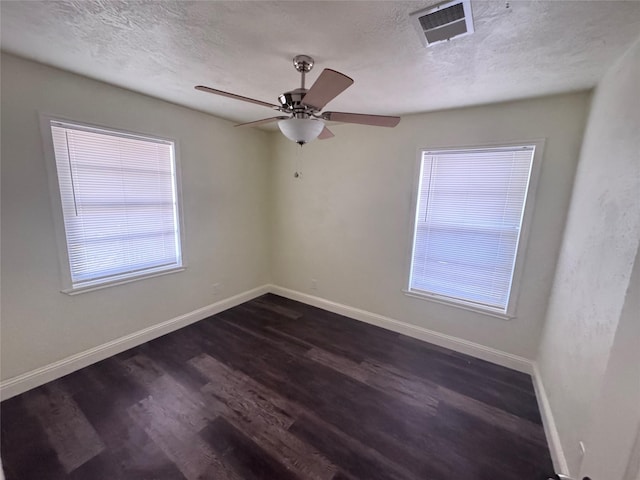 10124 Homestead Rd, Houston, TX 77016 - unfurnished room featuring dark wood-style floors, ceiling fan, and a textured ceiling