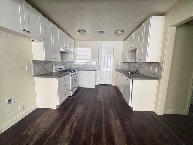10124 Homestead Rd, Houston, TX 77016 - kitchen featuring white appliances, under cabinet range hood, dark wood-style floors, and decorative backsplash